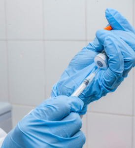 Doctor filling syringe