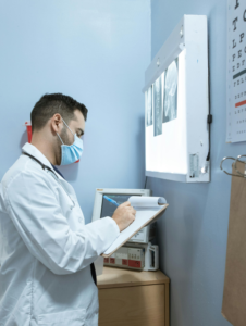 Doctor writing on paper